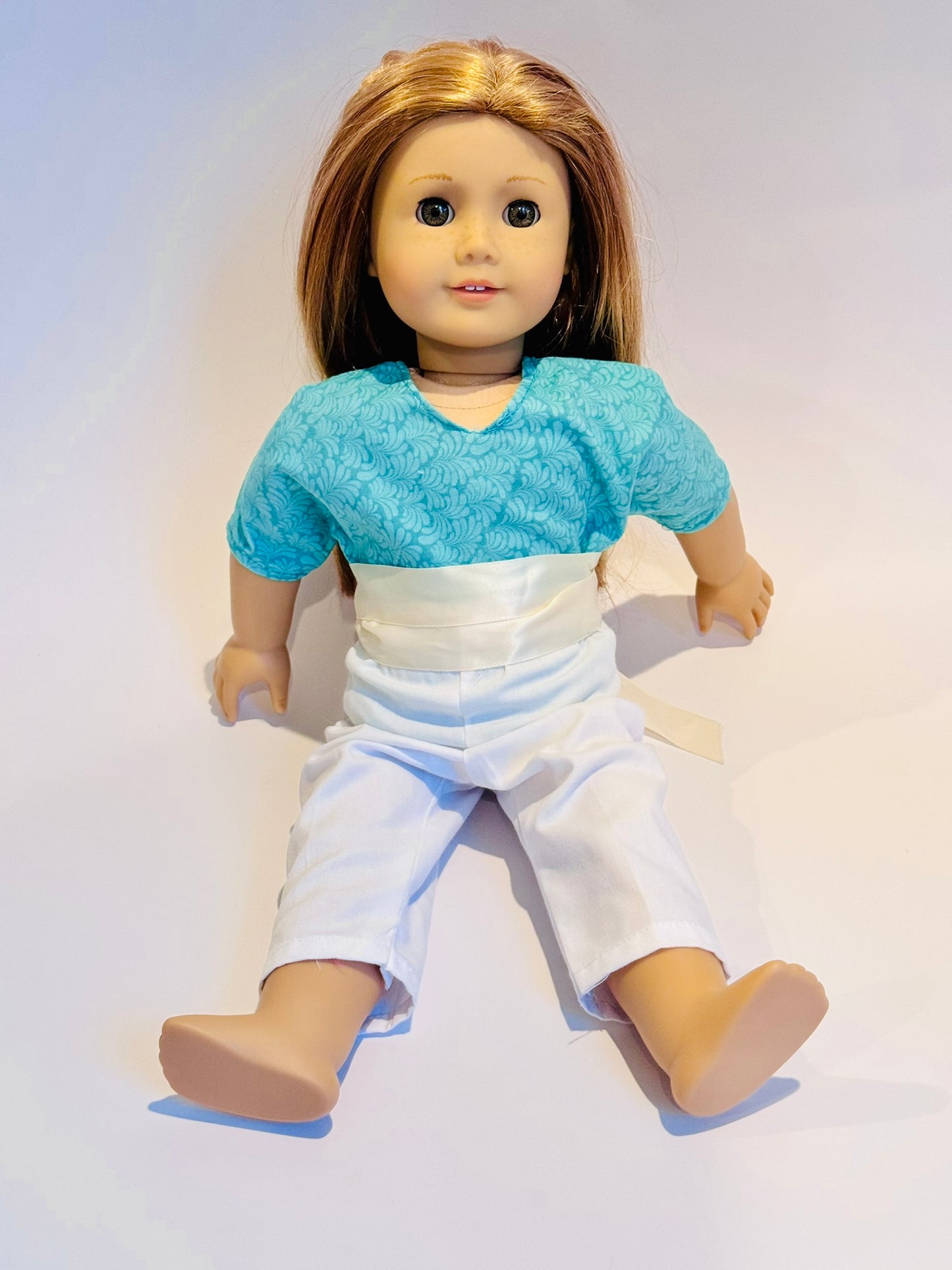 3-piece outfit made by Kathleen Saviak: aqua frill top with white slacks and coordinating ribbon