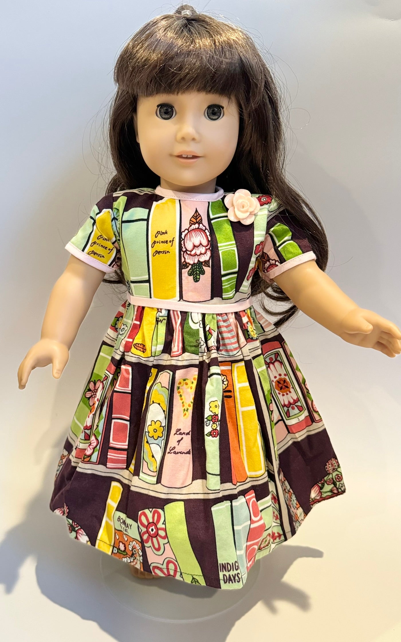 Dress made by Kathleen Saviak: "bookshelf" print with pink trim