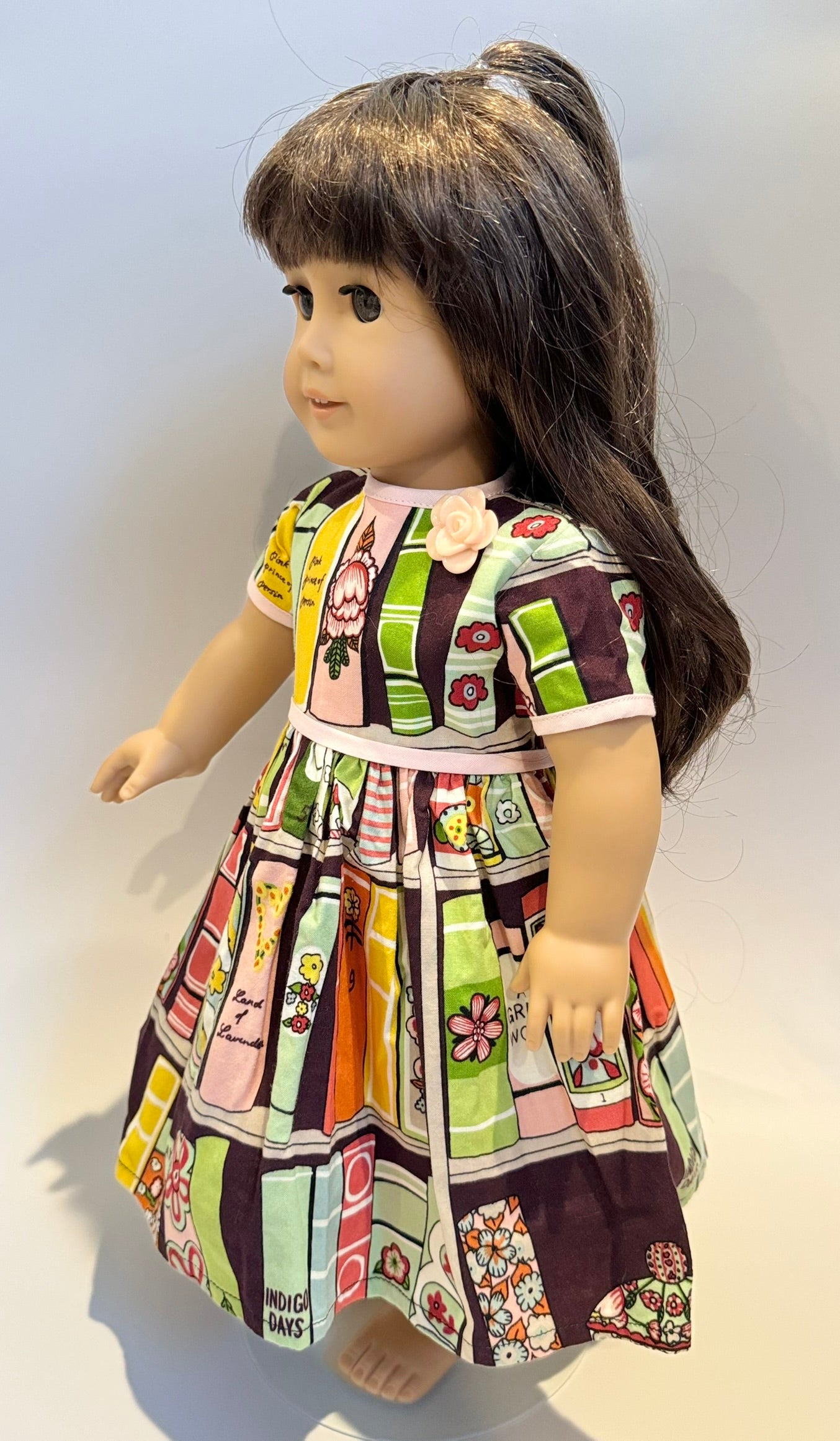 Dress made by Kathleen Saviak: "bookshelf" print with pink trim