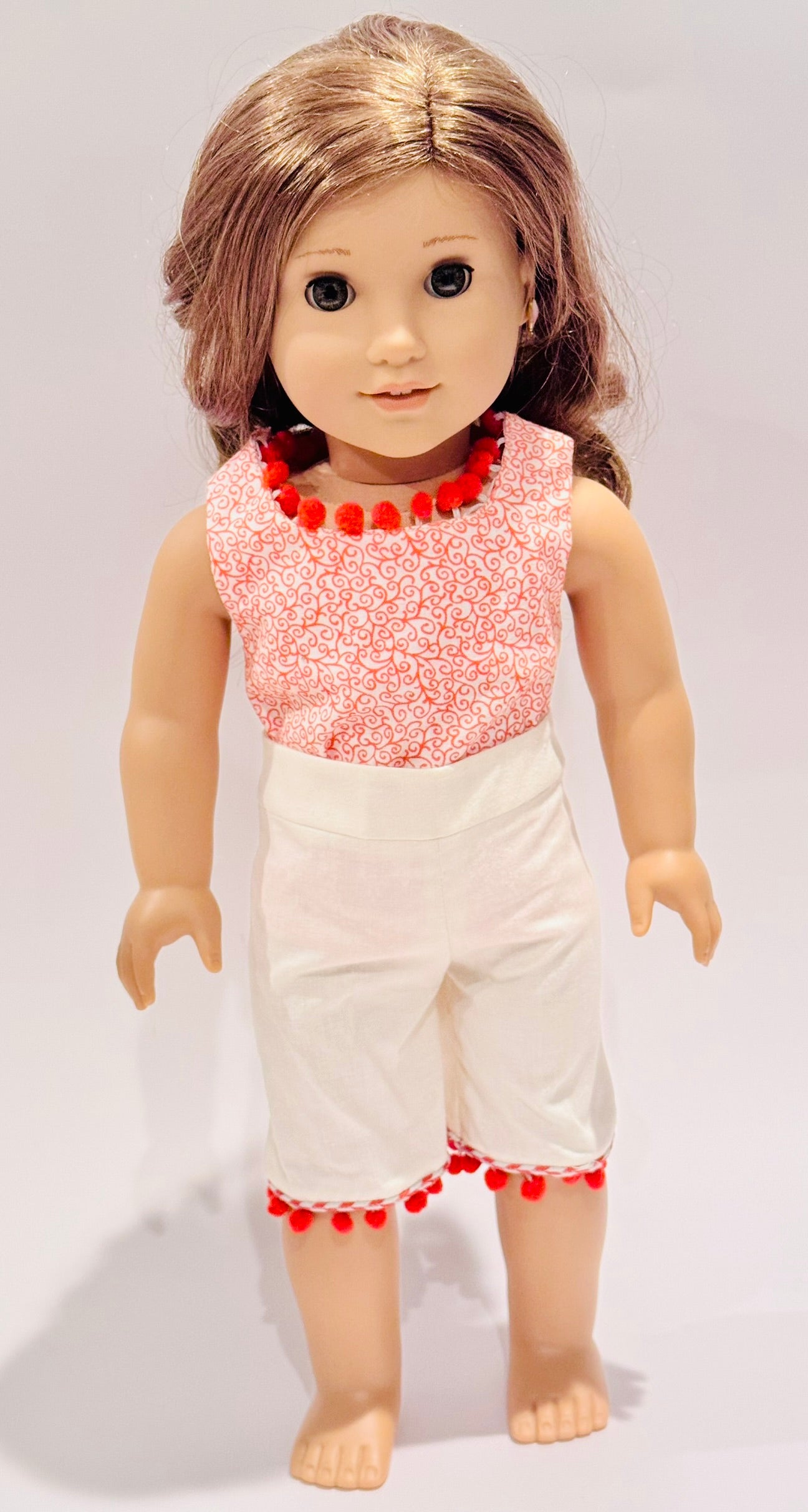 2-piece outfit made by Kathleen Saviak: orange paisley and pom-poms