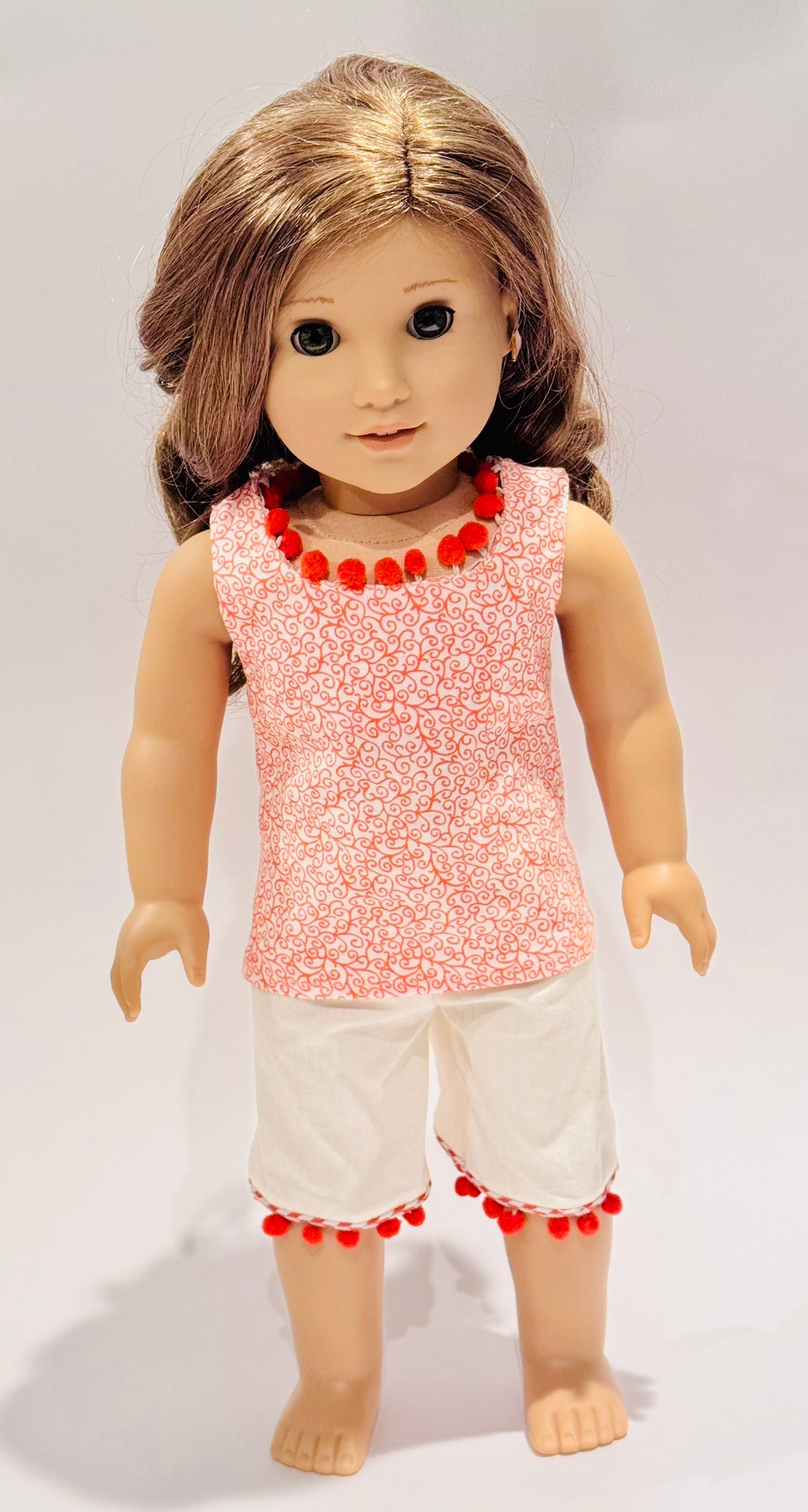 2-piece outfit made by Kathleen Saviak: orange paisley and pom-poms