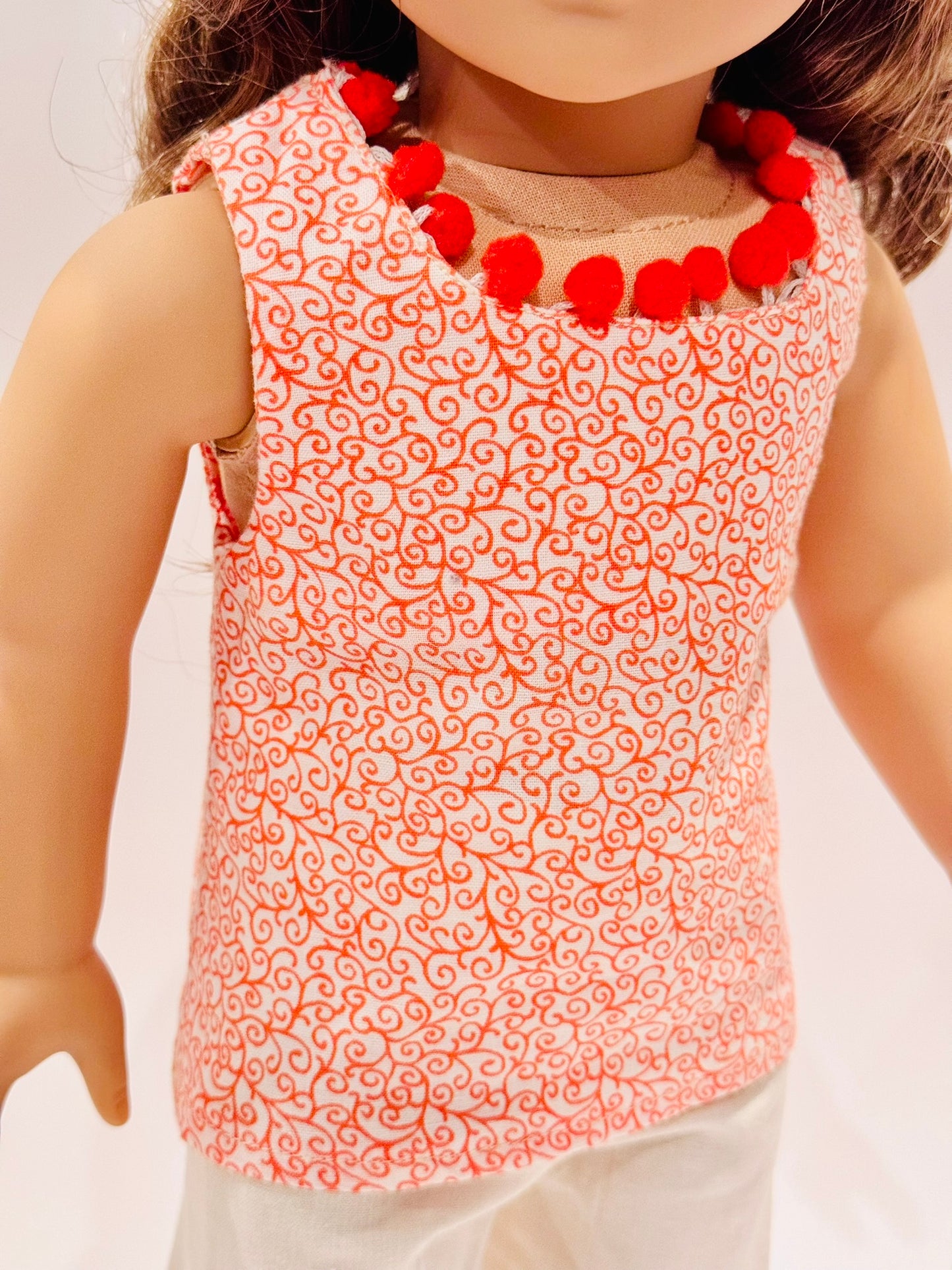 2-piece outfit made by Kathleen Saviak: orange paisley and pom-poms